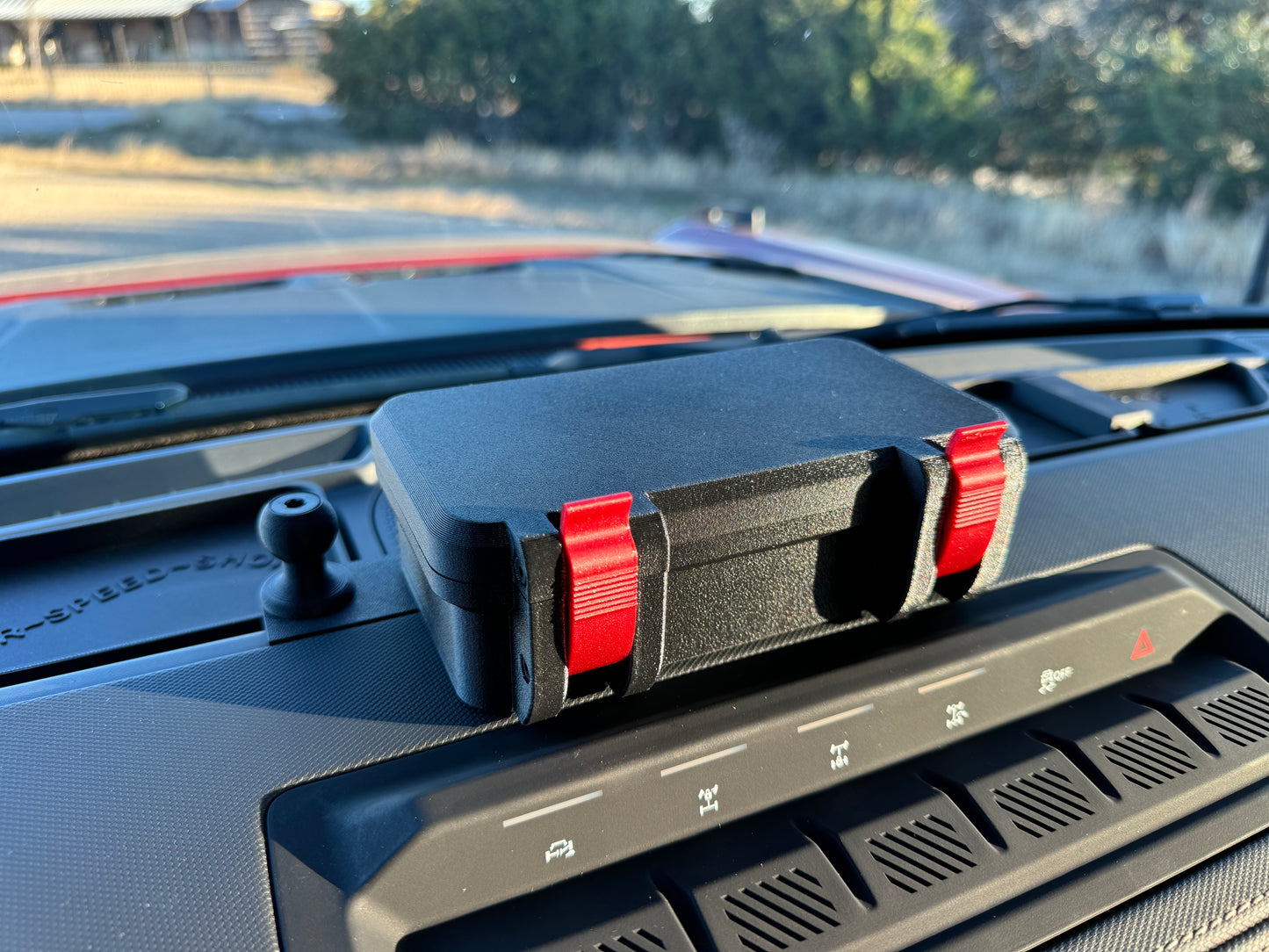 Storage box mounted on dash of Ford Bronco.